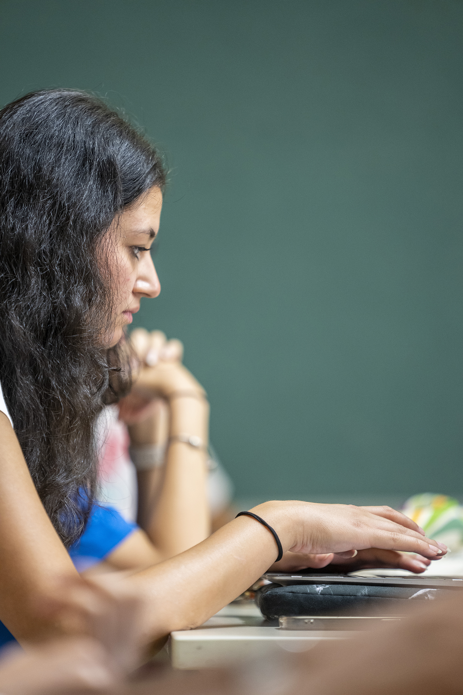 student working on laptop in class