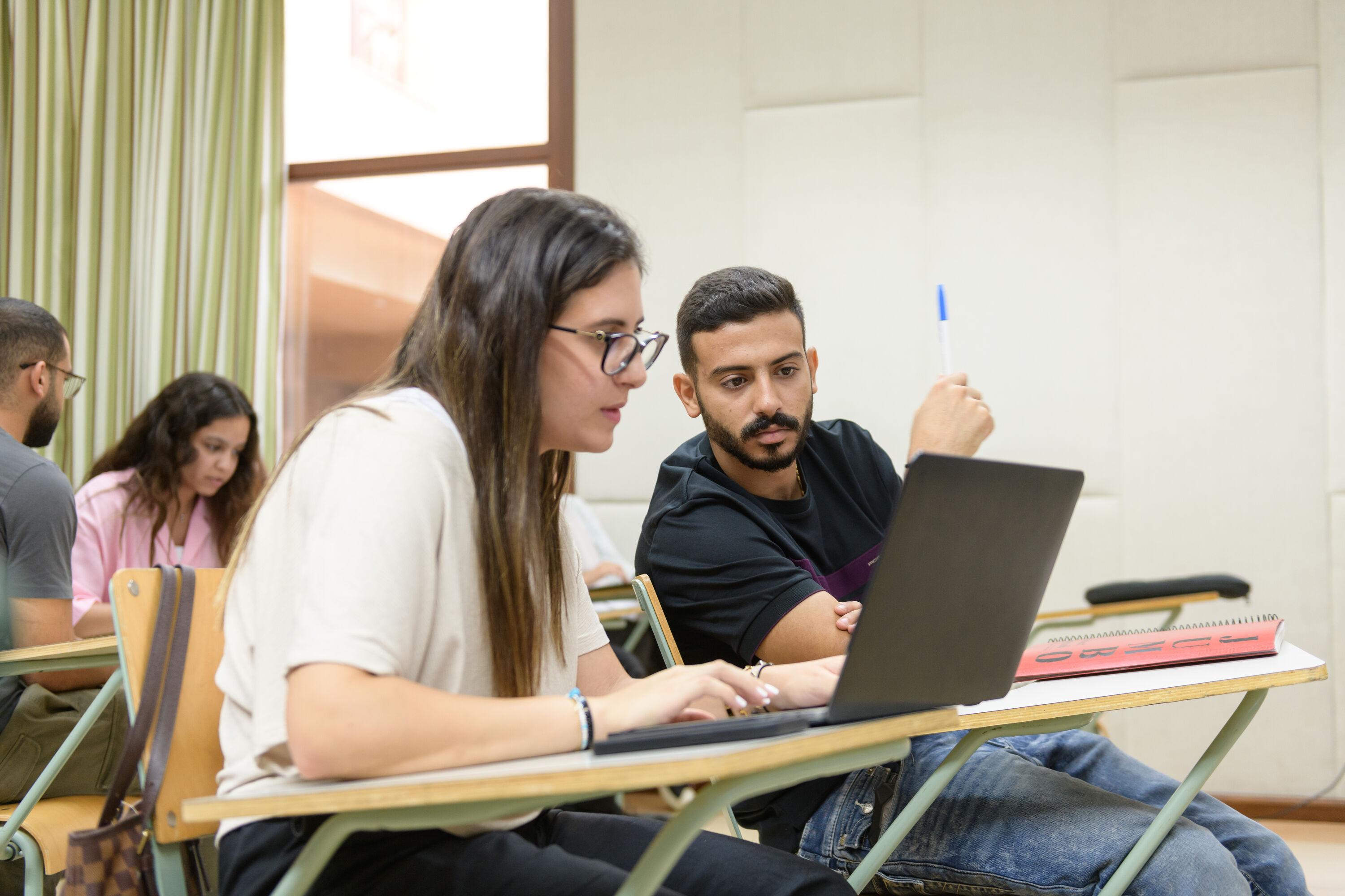 Economics Program image of female student discussing information with her group partner in class