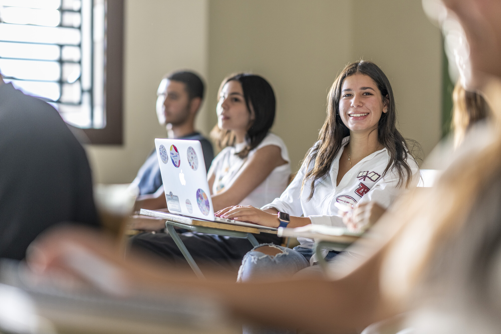 Smiling female student in classroom