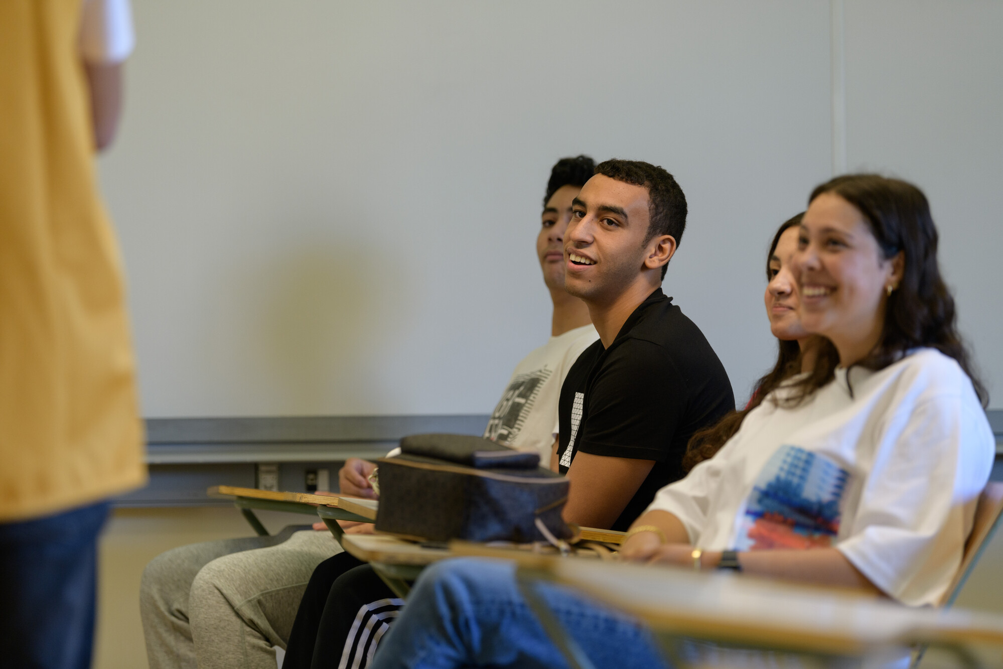 Smiling students in class attending class  