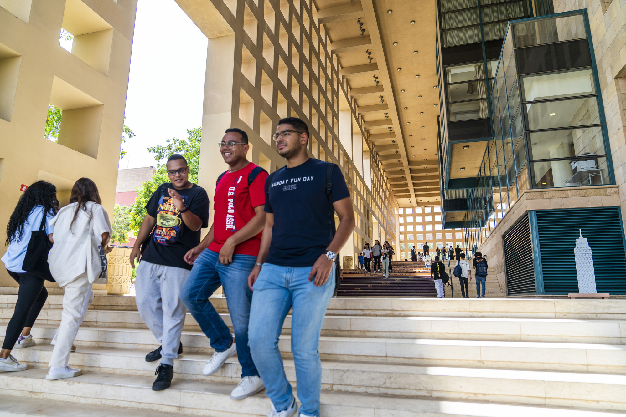 Students going down the stairs outside the library