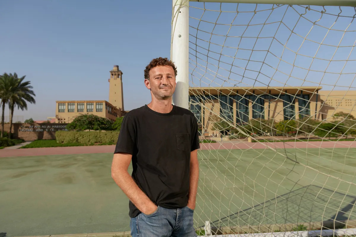 A man is standing in a football field