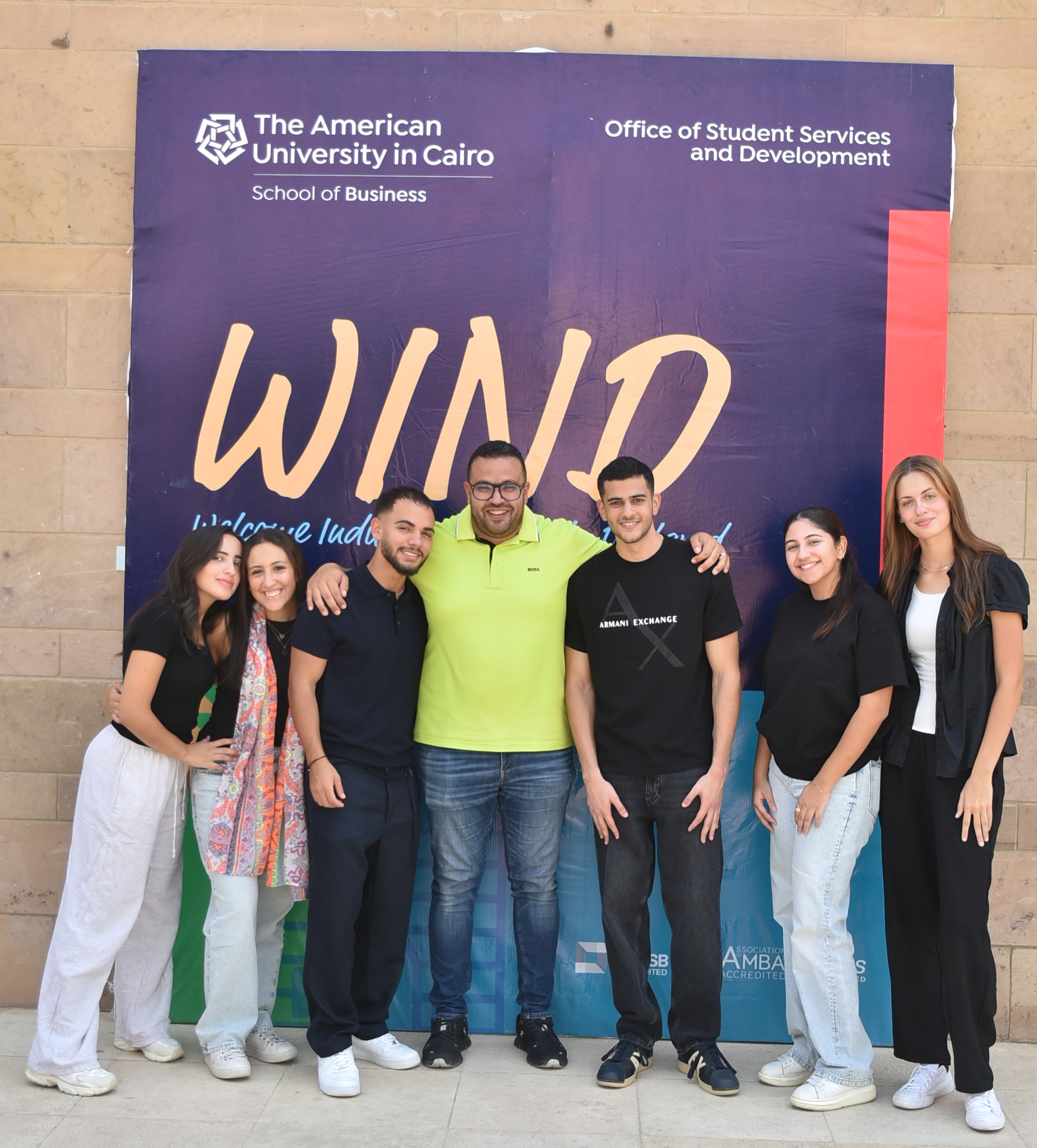 Students standing infront of WIND banner