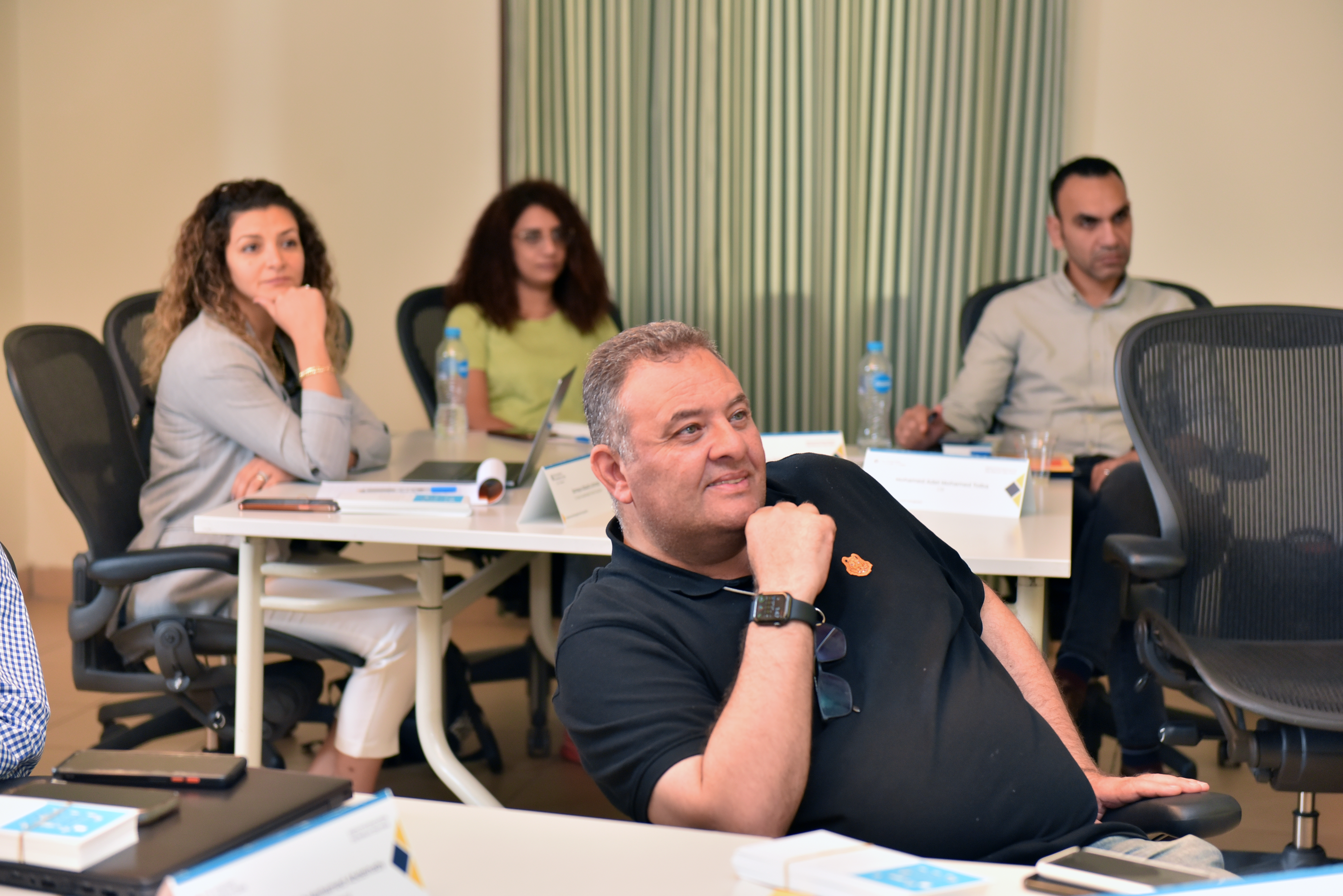 A middle aged man focusing in class