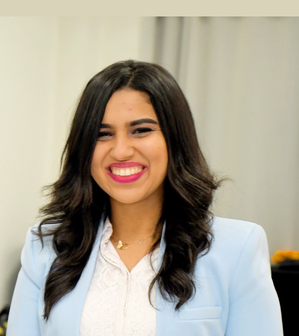 Lady wearing a blue suit smiling