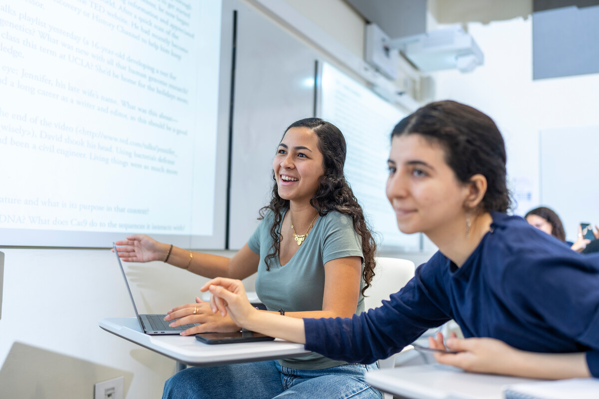 students in classroom using smart board during lecture