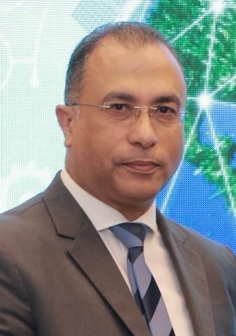 Headshot of a man wearing suit and tie