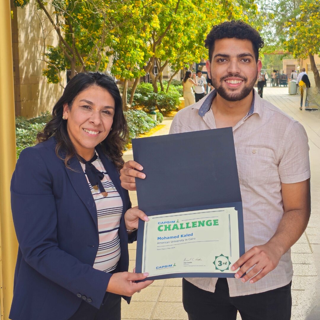 mohamed khaled AUC student holding certificate of winning 3rd place in capsim competition