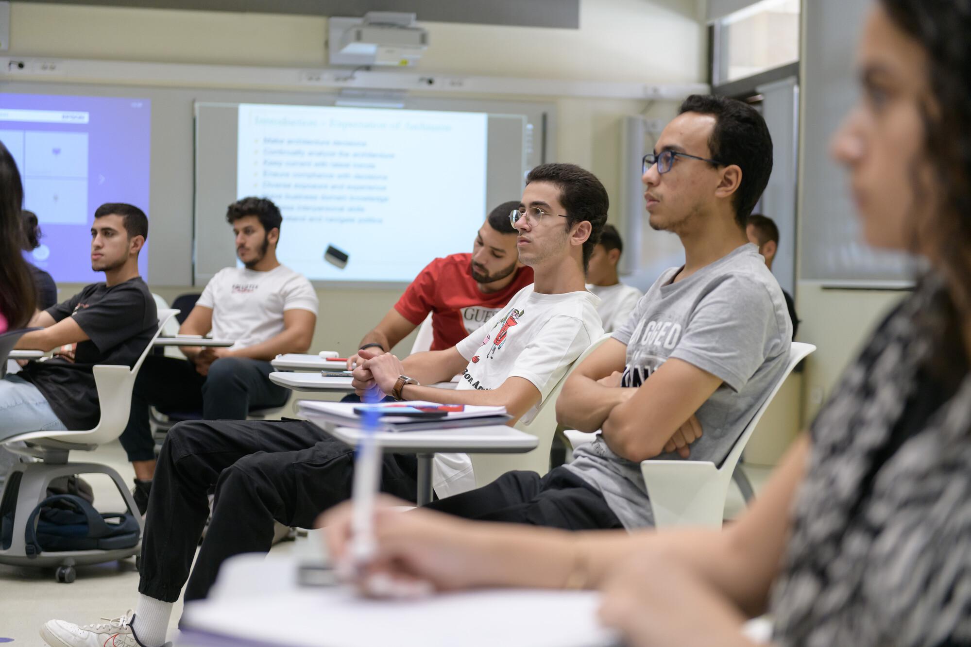 students writing and focusing in class