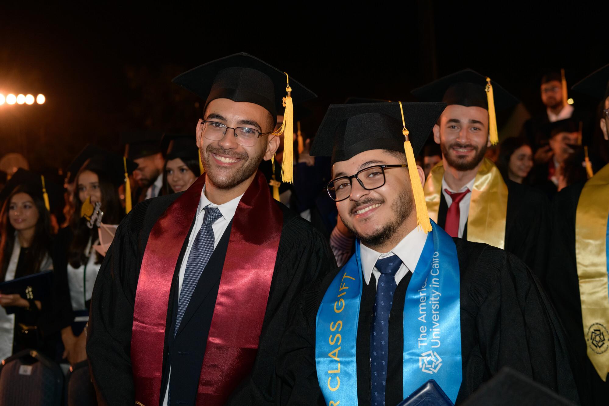students wearing cap and gown in commencement