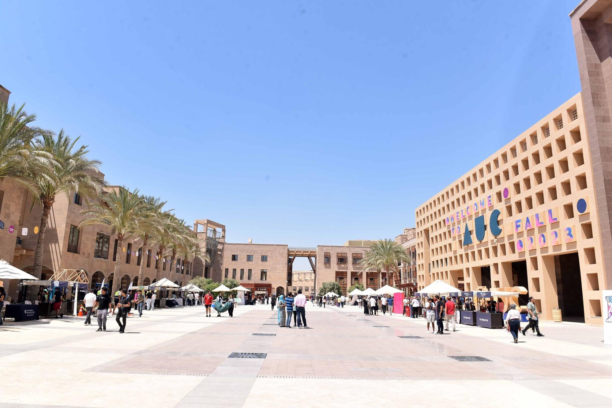 AUC campus plaza with students walking on campus