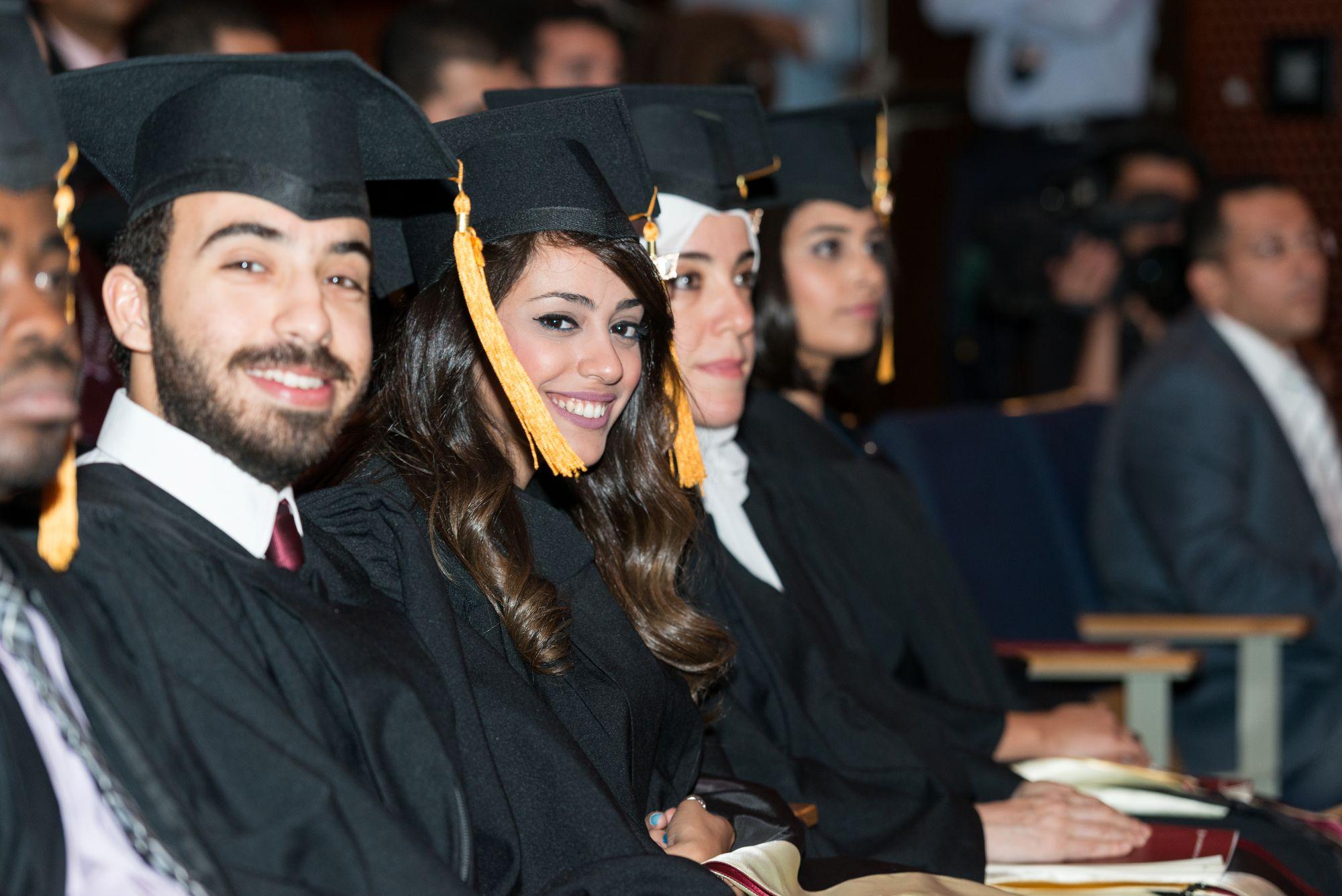 students in commencement graduating and smiling