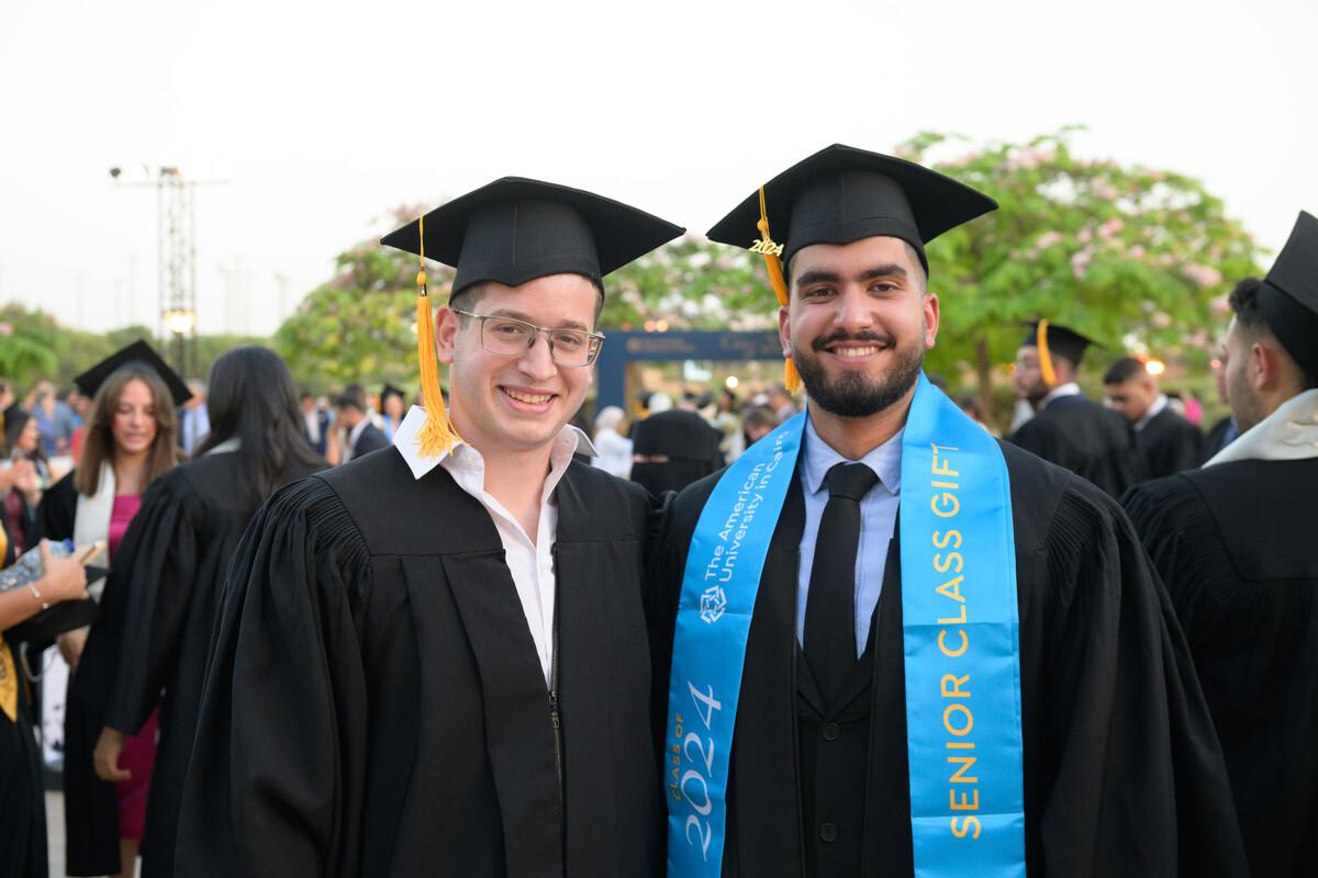 students graduating wearing cap and gown