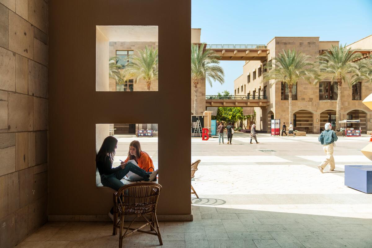 students in the plaza sitting outside chatting