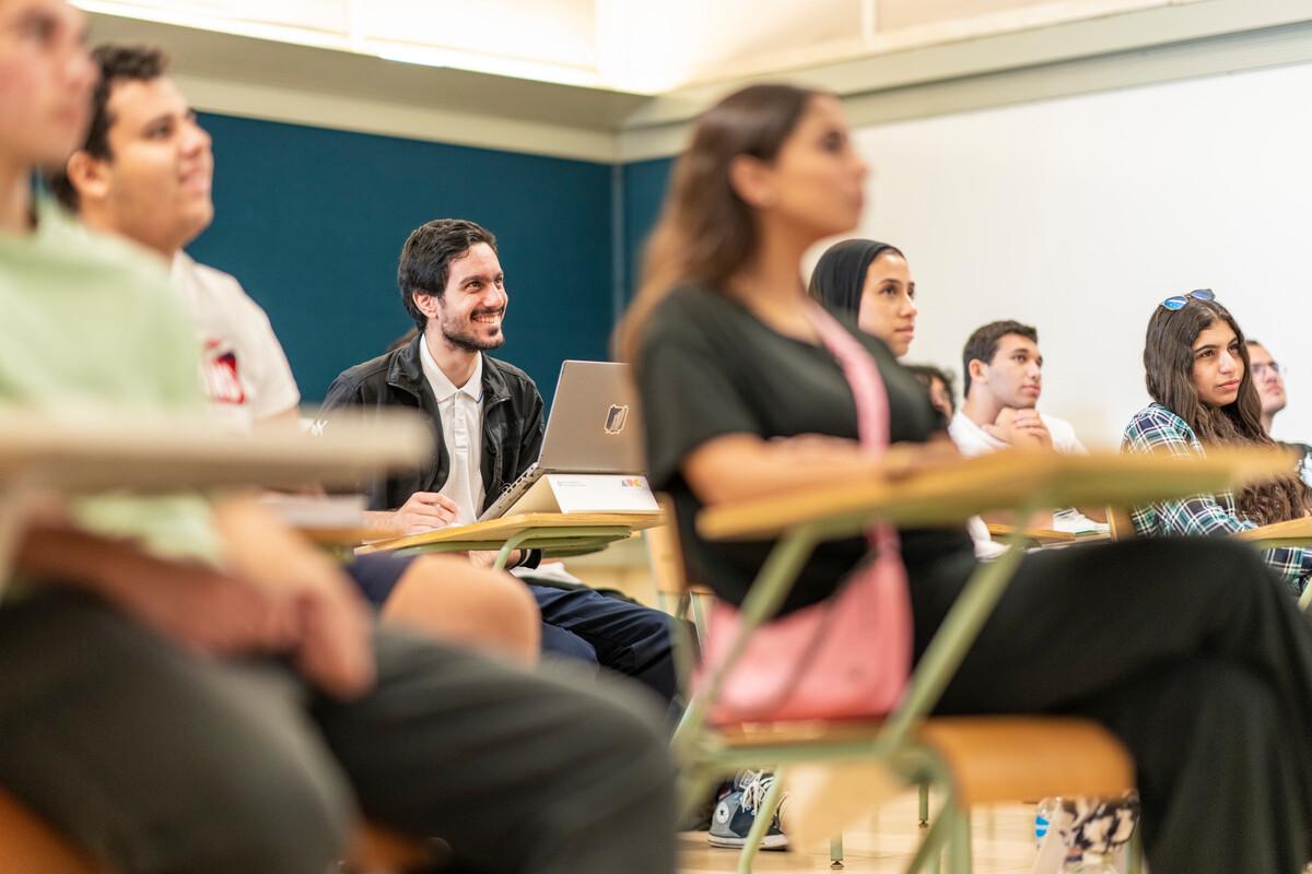 student attentive in classroom taking notes