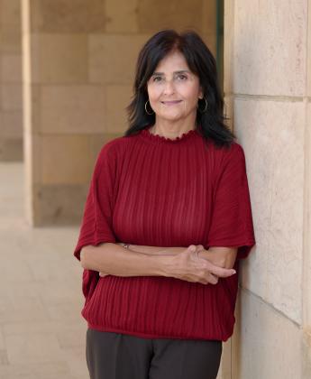 Maysa Ayoub leaning against a concrete wall