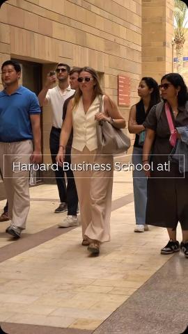 International students walking. Text: Harvard Business School at...