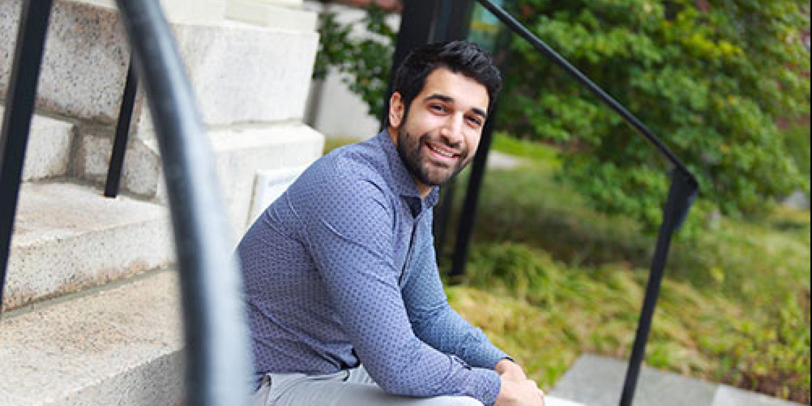 a young man sitting on stairs