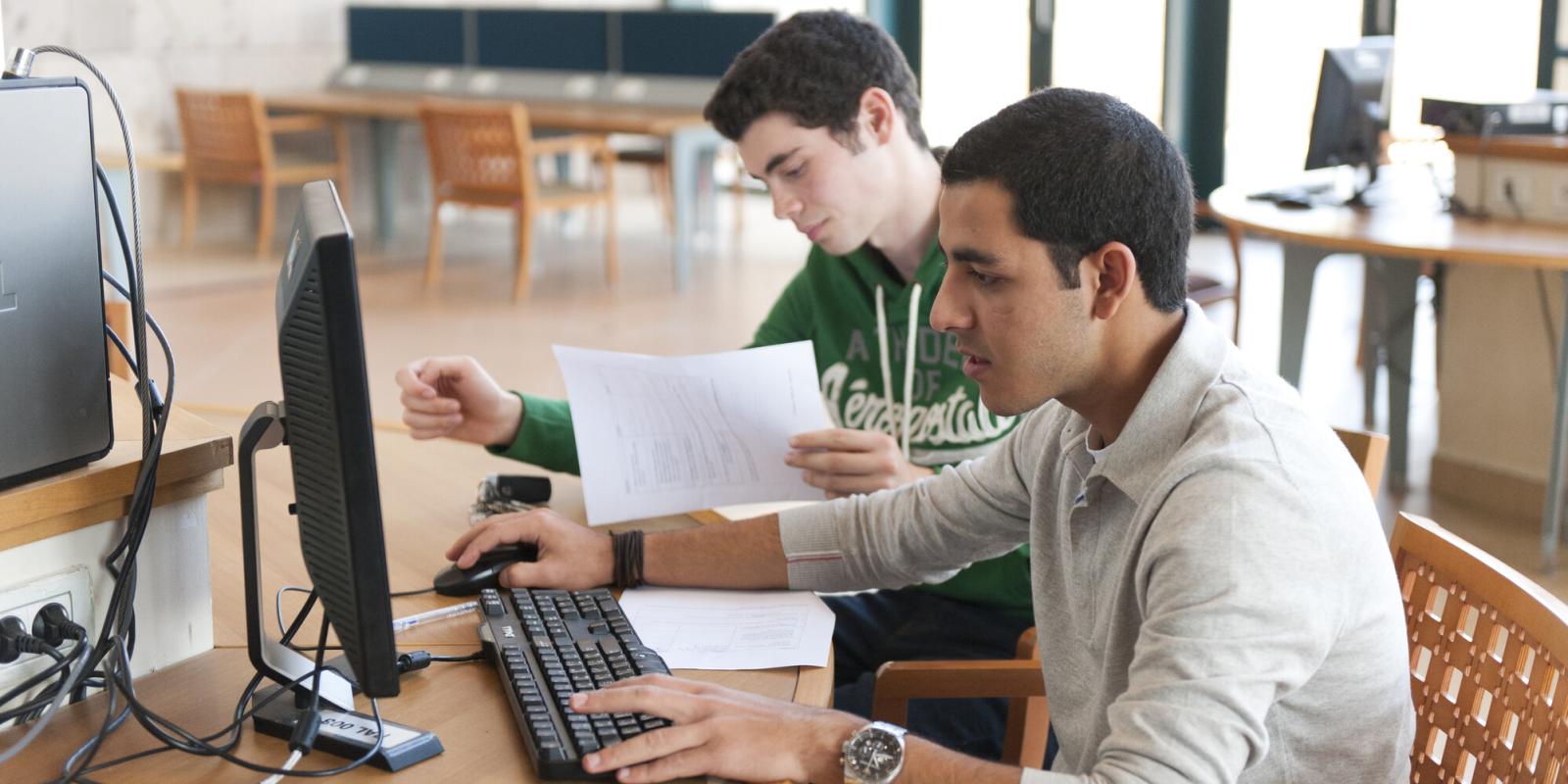 Students using laptops and working
