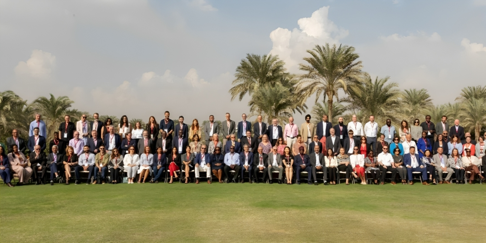 A group picture of men and women in a garden