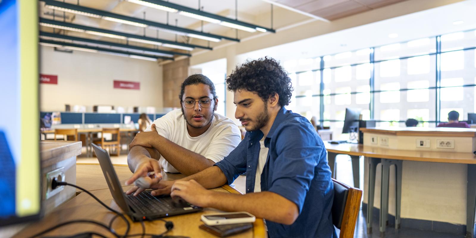 students working on project on a laptop