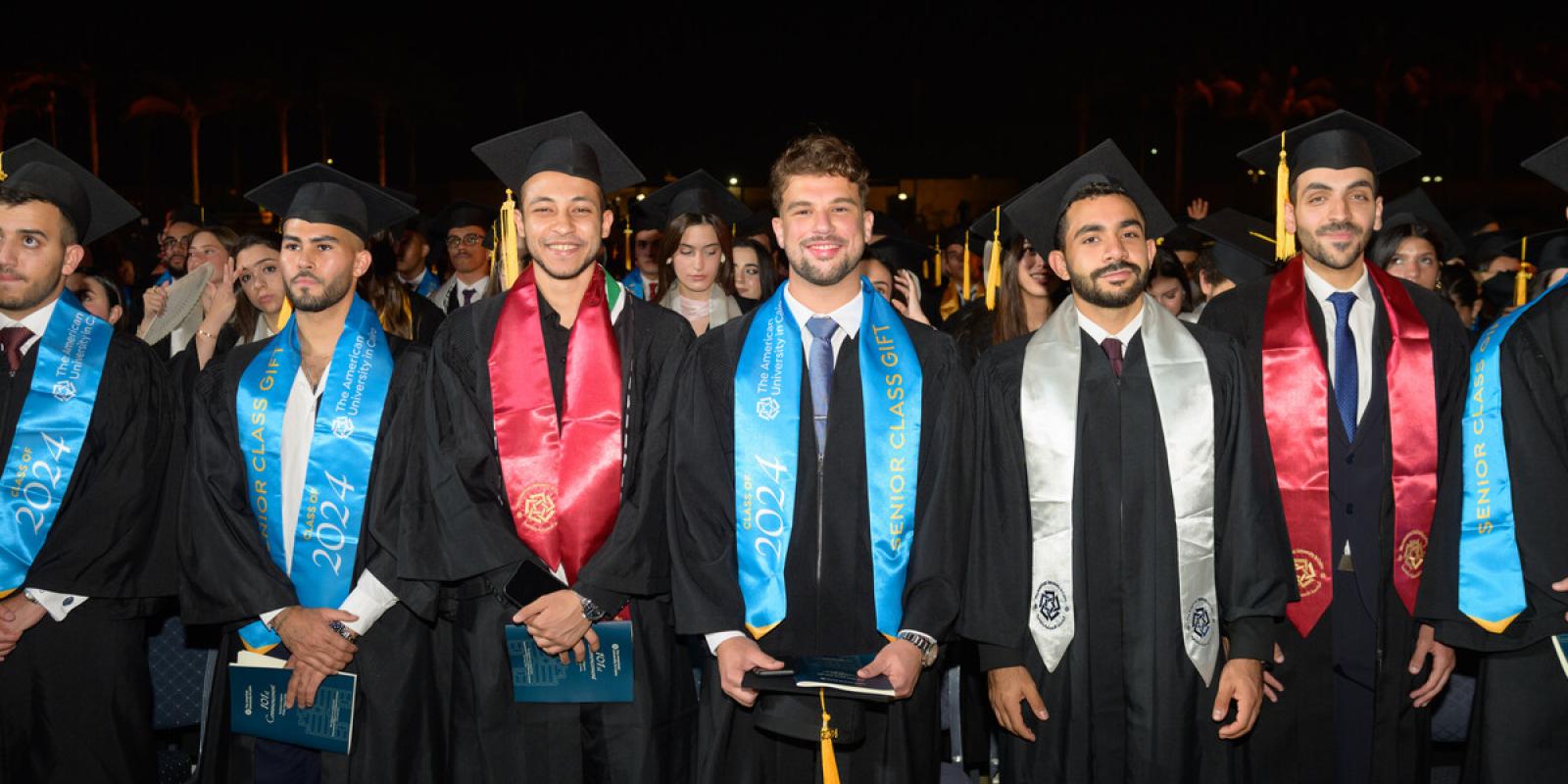graduating students wearing cap and gown during commencement