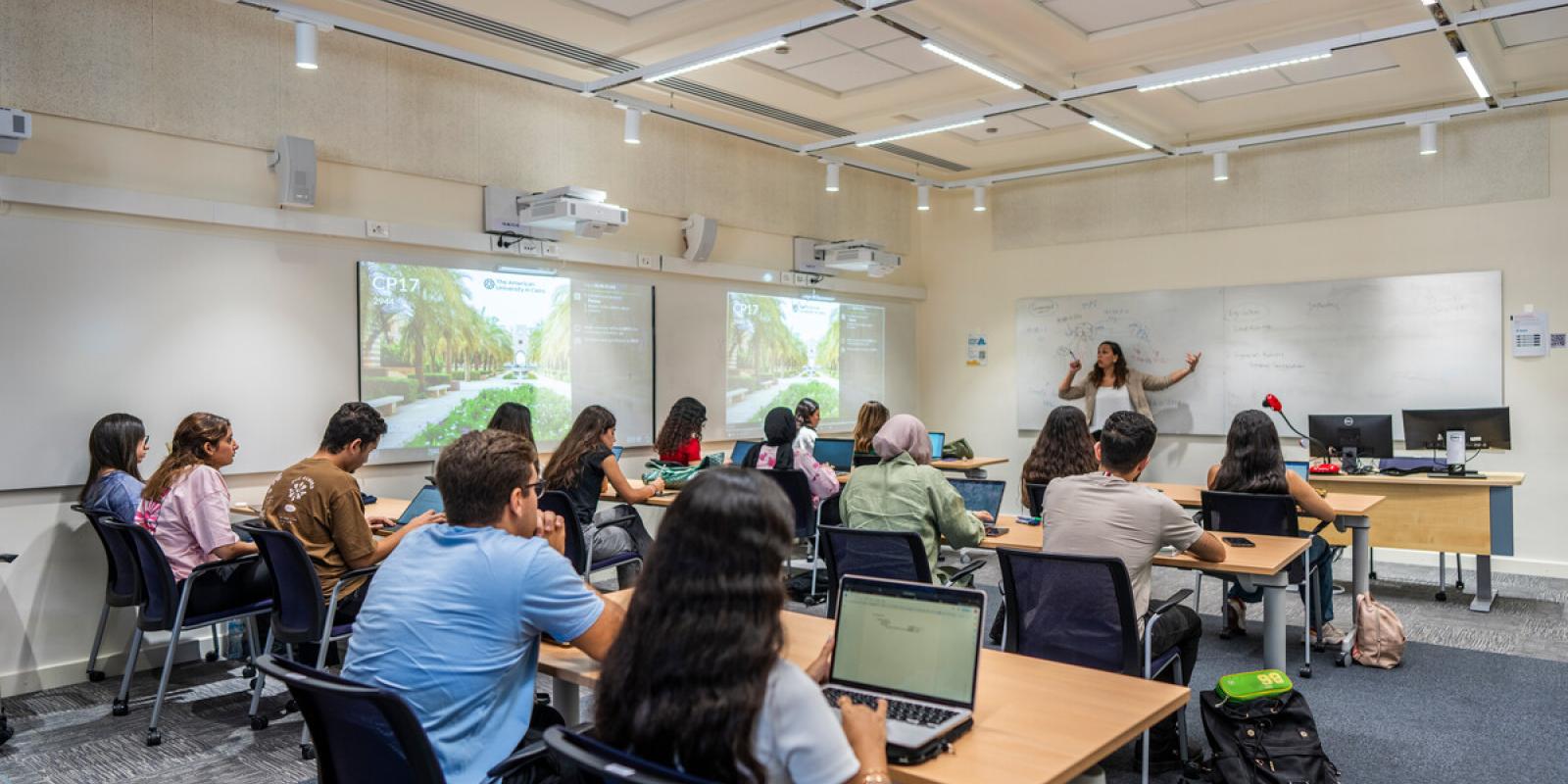 students attending class and focusing on professor giving lecture