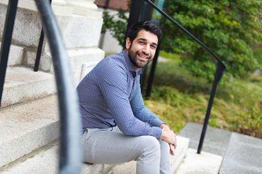 a young man sitting on stairs