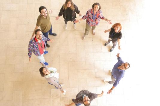 Group of people standing in a circle