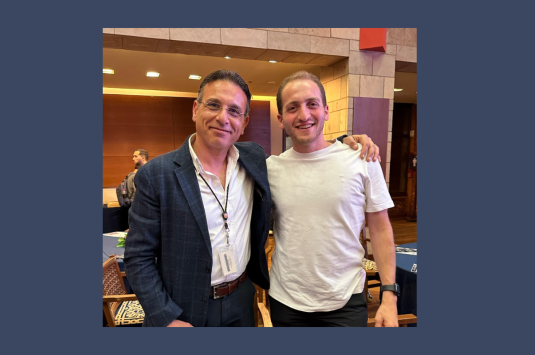 Two men standing together smiling