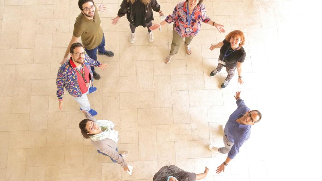 Group of people standing in a circle