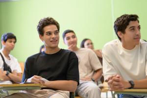 male students in class focusing on discussions