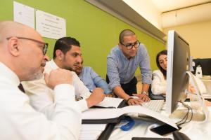 graduate students working on project in class