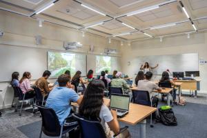 students attending class and professor explaining