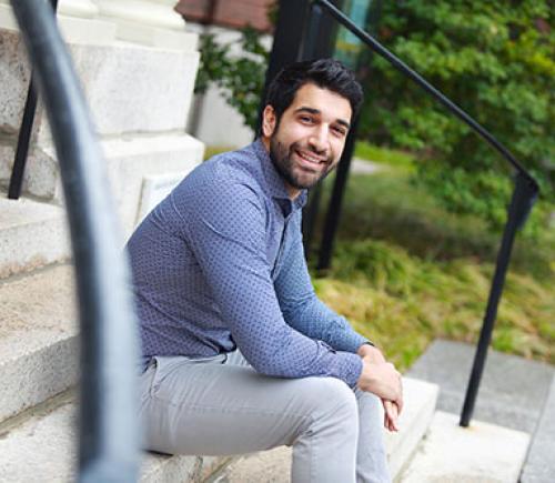 a young man sitting on stairs