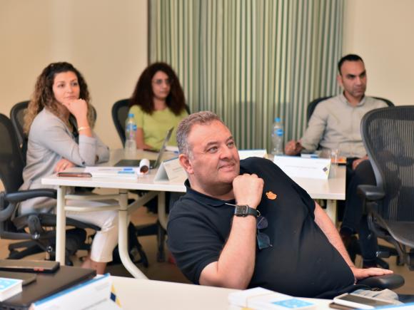 A middle aged man focusing in class