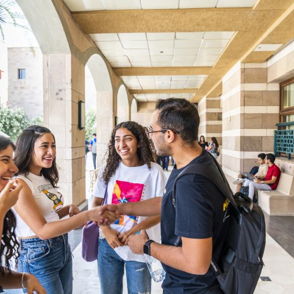 students greeting each other on campus