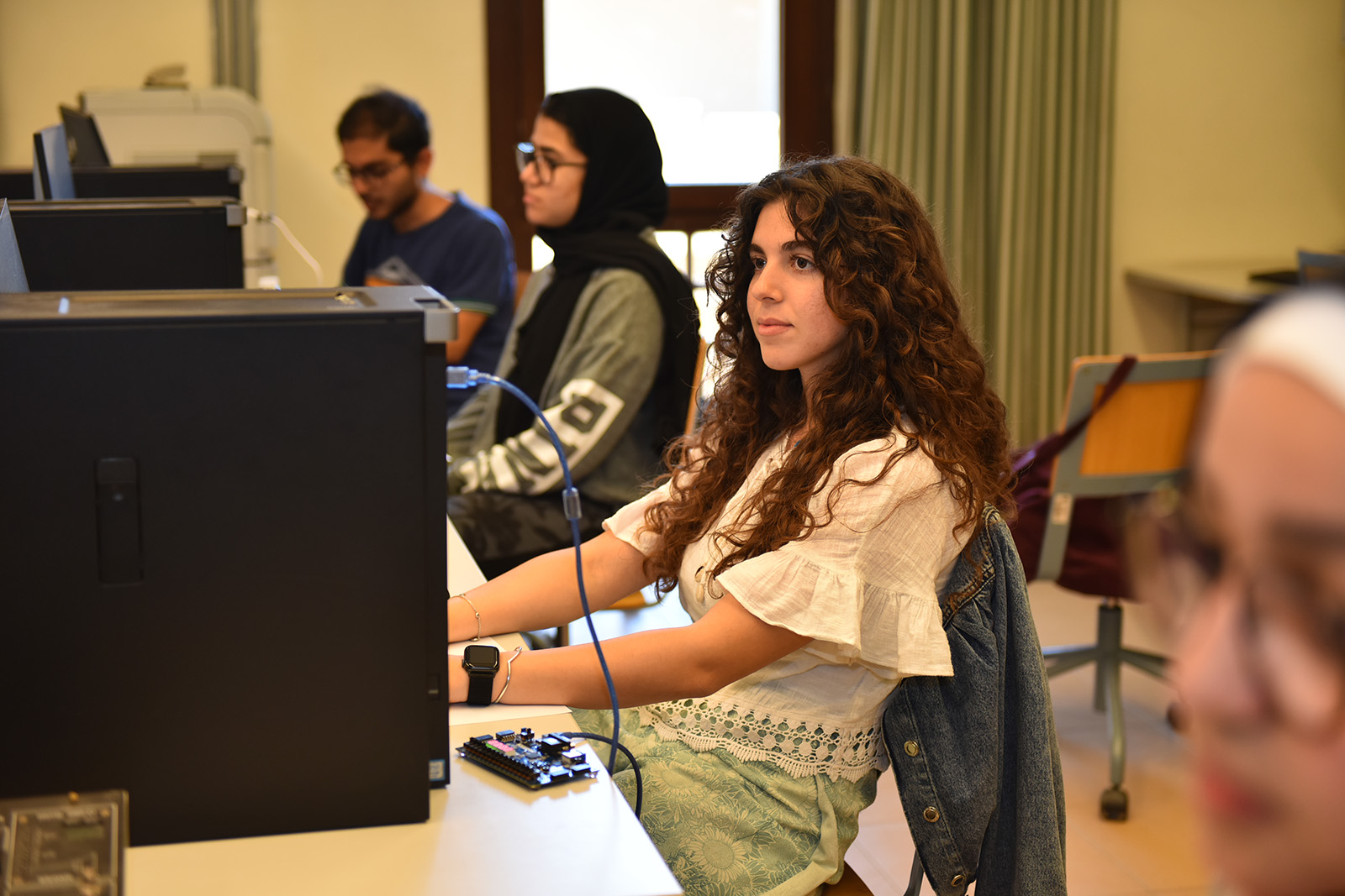 Students siting in a computer lab